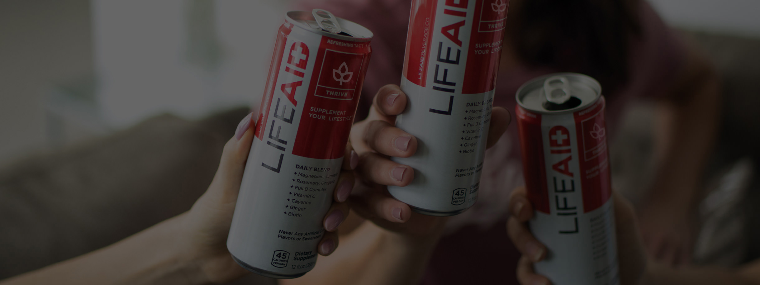 background image of hands holding LIFEAID cans