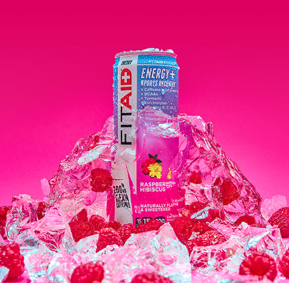 A can of FITAID Energy Raspberry Hibiscus surrounded by raspberry and ice cubes.