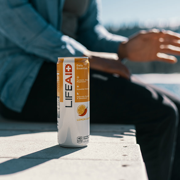 A man sitting beside a can of LIFEAID.