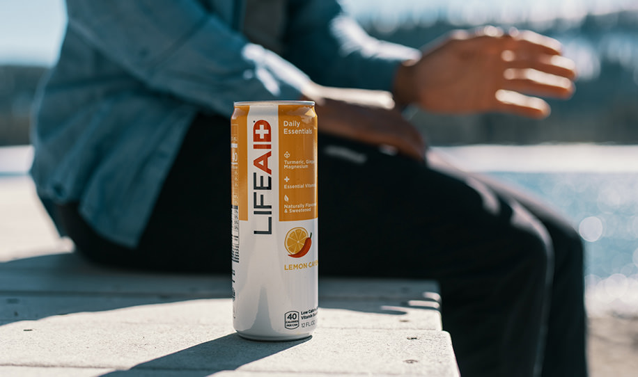 A man sitting beside a can of LIFEAID.